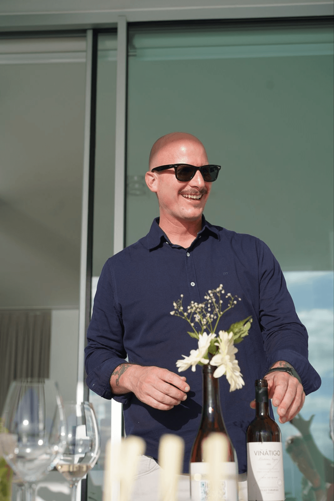 Portrait of Lorenzo Artioli, sommelier in Tenerife, looking at a glass of wine at sunset